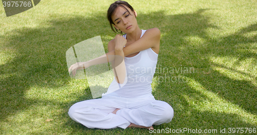 Image of Pretty single woman in empty yard stretching arms