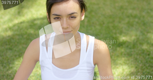 Image of Calm young woman in white blouse with grin