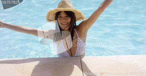 Image of Young woman celebrating the summer sunshine