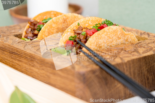 Image of fresh mexican taco shells with beef and vegetables