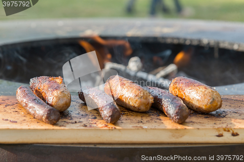 Image of Grilling sausages on barbecue grill