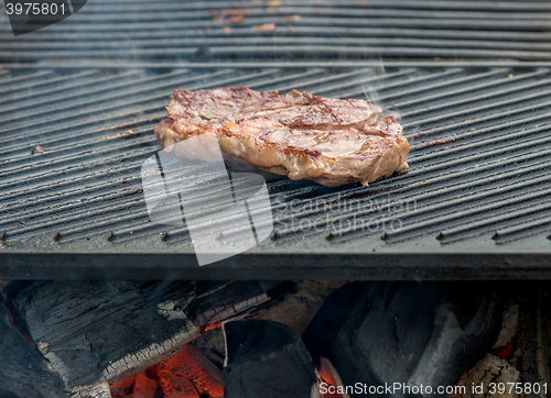 Image of beef steaks on the grill