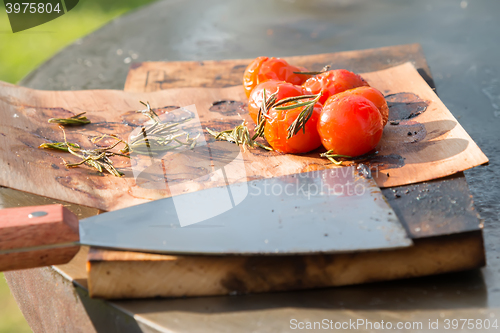 Image of tomatoes on the grill pan  the table