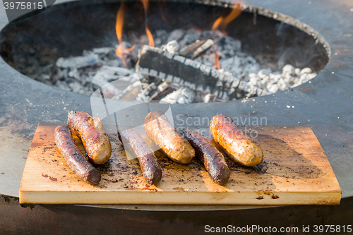 Image of Grilling sausages on barbecue grill