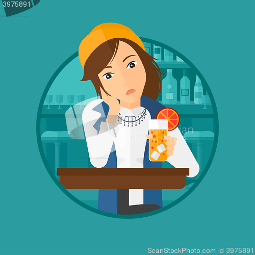 Image of Woman drinking orange cocktail at the bar.