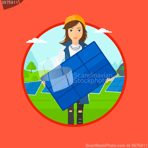 Image of Woman holding solar panel.