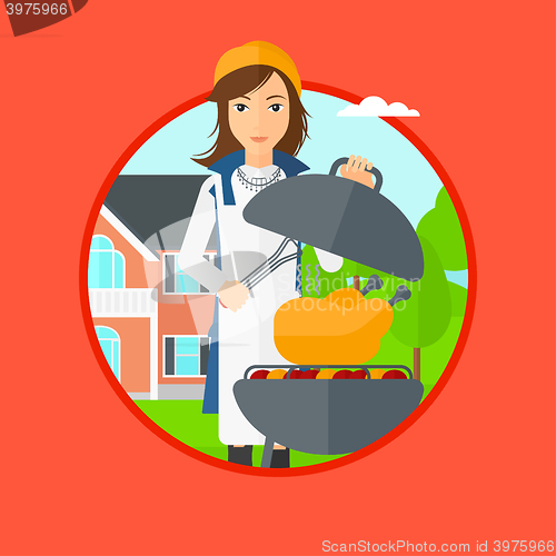 Image of Woman cooking chicken on barbecue grill.