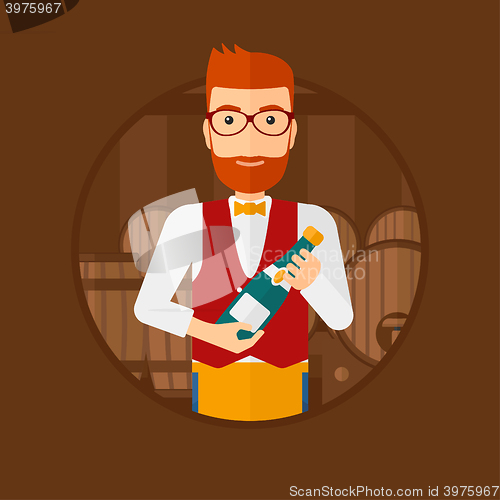 Image of Waiter holding bottle in wine cellar.