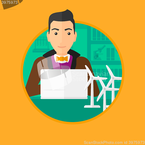 Image of Man working with model wind turbines on the table.