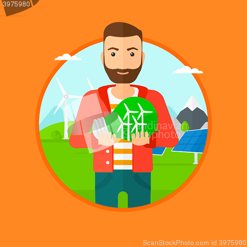 Image of Man holding lightbulb with wind turbines inside.