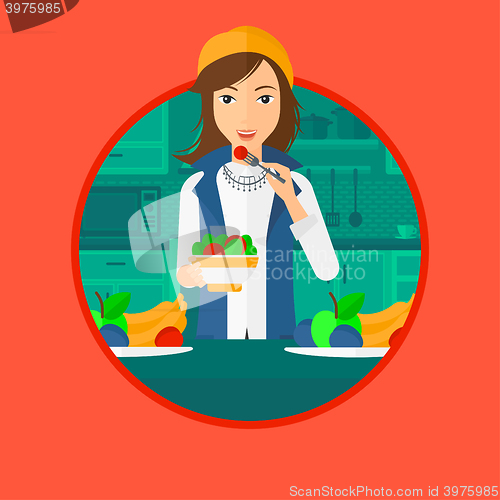 Image of Woman eating healthy vegetable salad.