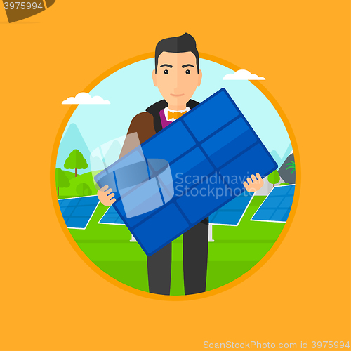 Image of Man holding solar panel.