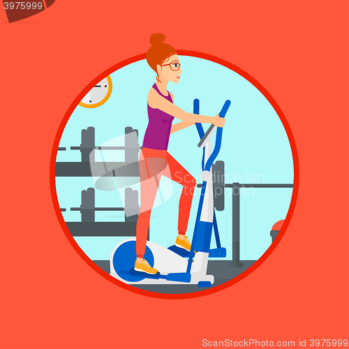 Image of Woman exercising on elliptical trainer.