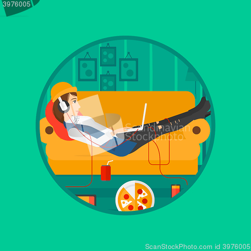 Image of Woman lying on sofa with many gadgets.