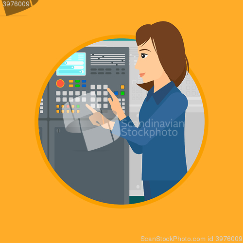 Image of Engineer standing near control panel.