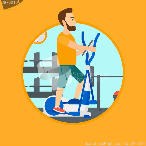 Image of Man exercising on elliptical trainer.