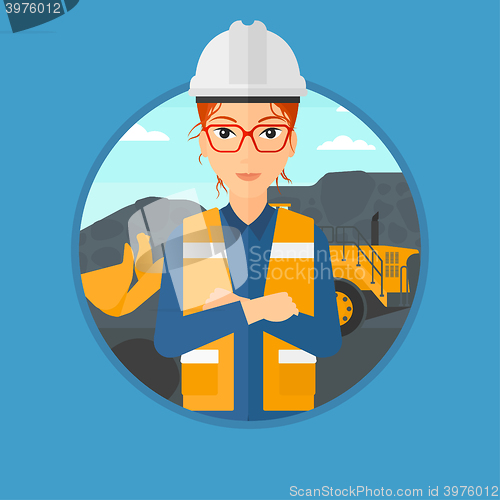 Image of Miner with a big excavator on background.