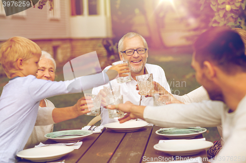 Image of happy family having holiday dinner outdoors