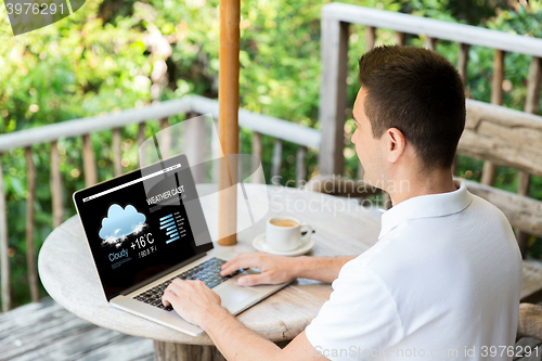 Image of close up of businessman with laptop on terrace