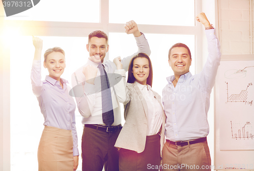 Image of business team celebrating victory in office