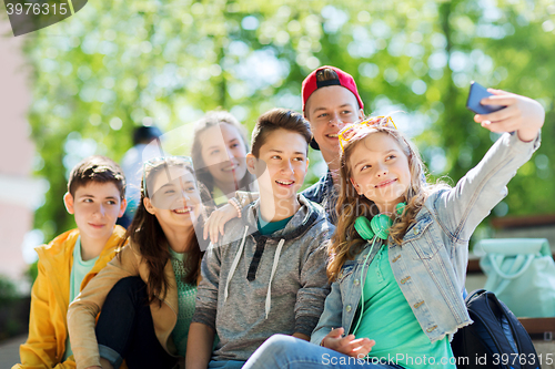 Image of happy teenage students taking selfie by smartphone