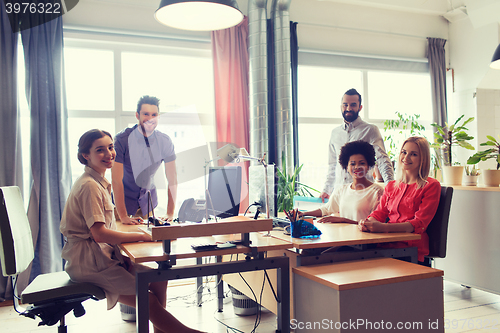 Image of happy creative team in office