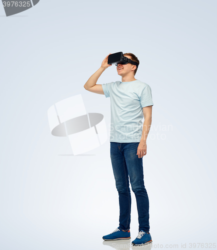 Image of happy man in virtual reality headset or 3d glasses