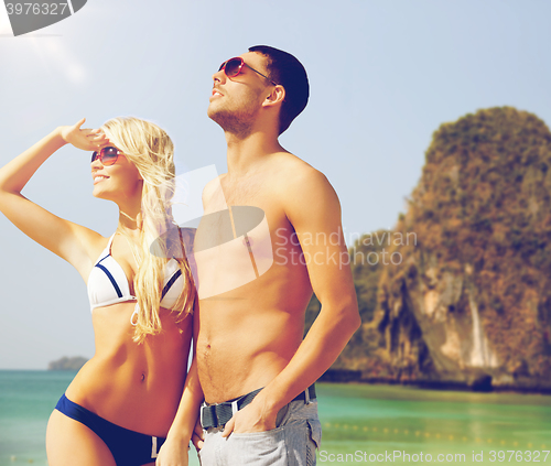 Image of happy couple over exotic tropical beach background