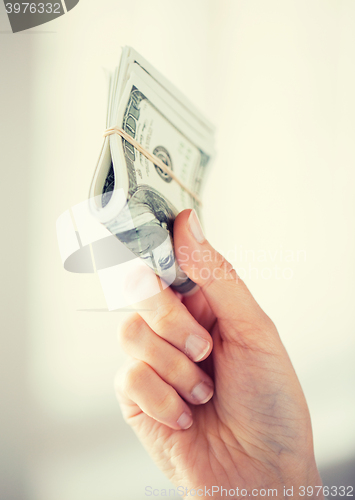 Image of close up of woman hands holding us dollar money