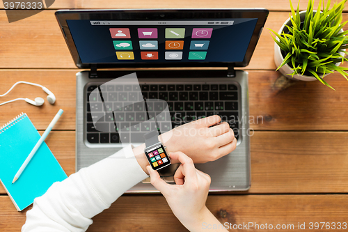 Image of close up of woman with smart watch and laptop