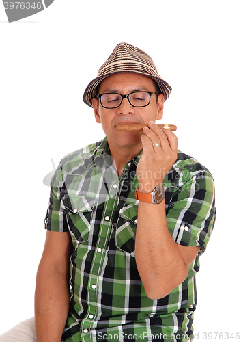 Image of Hispanic man enjoying his cigar.