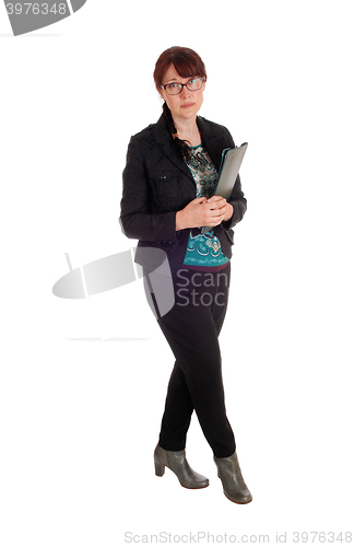Image of Businesswoman standing with clipboard.