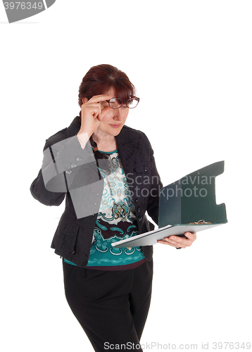 Image of Businesswoman looking on her clipboard.