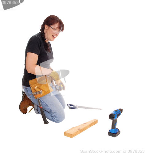 Image of Woman working with tools.