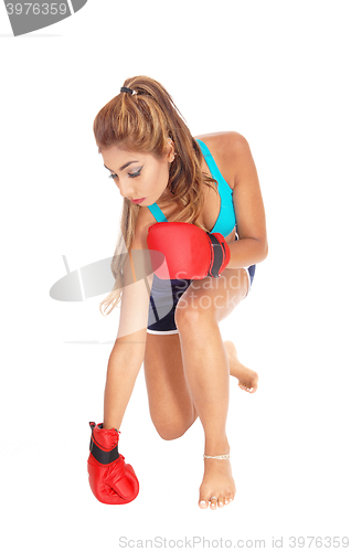 Image of Boxing woman kneeling.