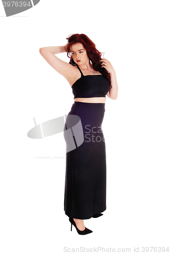 Image of Lovely girl in long skirt standing.