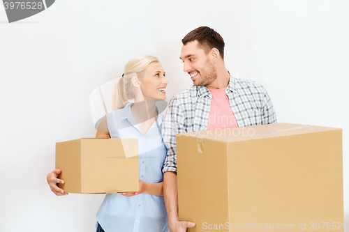 Image of couple with cardboard boxes moving to new home