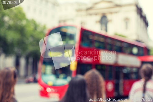 Image of city street with red double decker bus in london