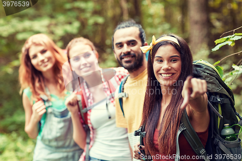 Image of group of smiling friends with backpacks hiking