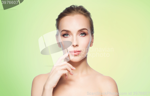Image of beautiful young woman showing her lips