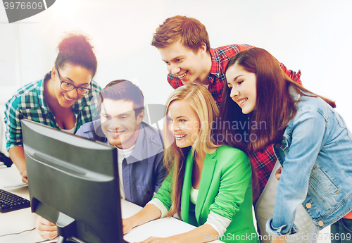 Image of students with computer studying at school