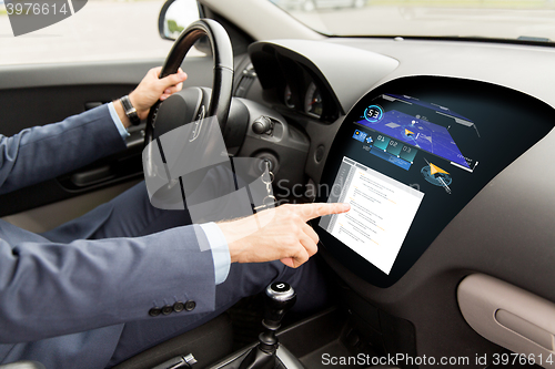 Image of close up of man driving car with navigation system