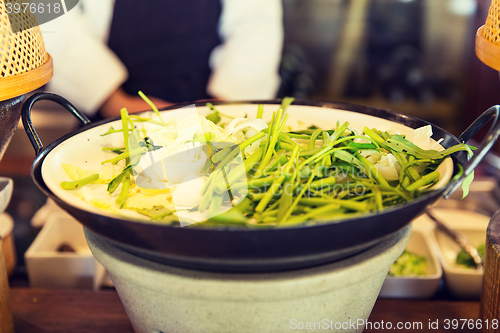 Image of bowl of green salad or garnish at asian restaurant
