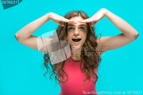 Image of Portrait of young woman with shocked facial expression