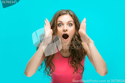 Image of Portrait of young woman with shocked facial expression