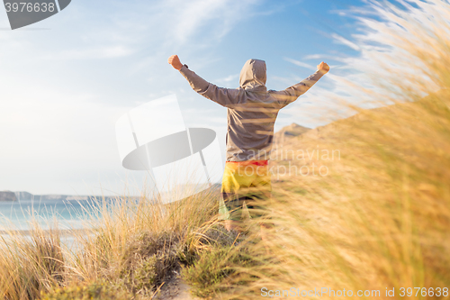 Image of Sporty active man enjoying beauty of nature.