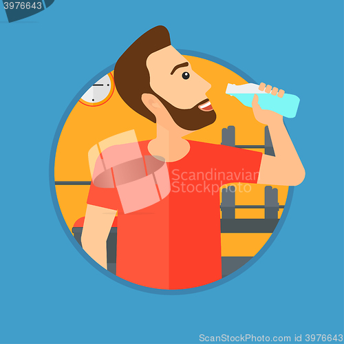 Image of Sportive man drinking water.