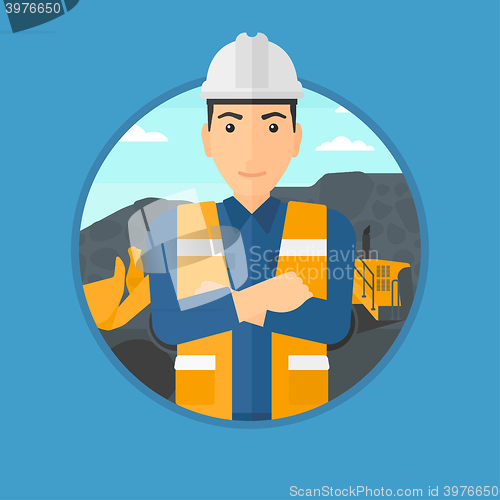 Image of Miner with a big excavator on background.