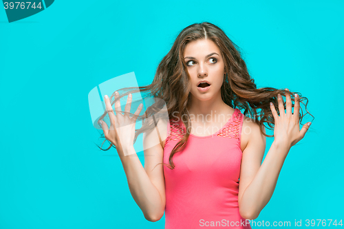 Image of Portrait of young woman with shocked facial expression