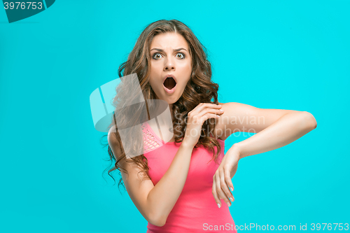 Image of Portrait of young woman with shocked facial expression